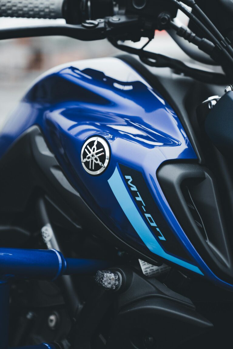 Artistic close-up view of Yamaha MT-07 showcasing its sleek blue bodywork and emblem.